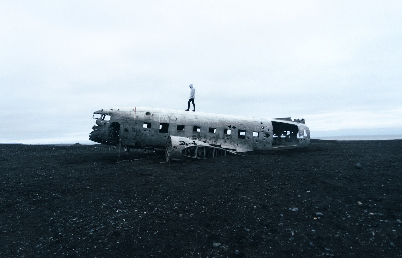 Person standing on wrecked plane