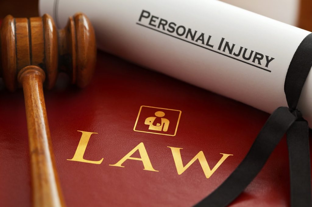 Personal injury attorney contract, book, and gavel