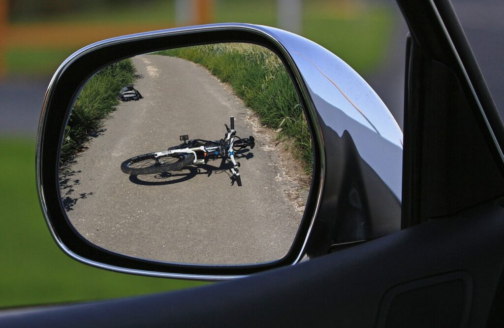 Bike accident in side mirror of car.