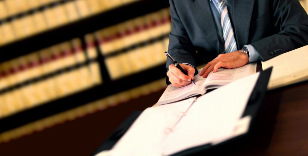 Lawyer writing notes on table