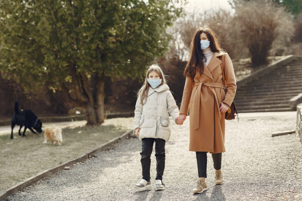 Mother & daughter walking with masks on