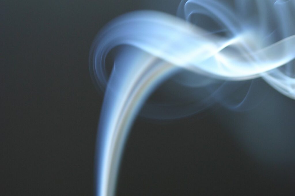 Fumes of gas flowing up on a black background