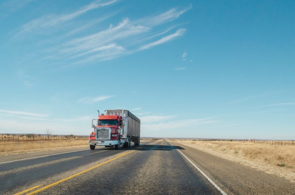 Red semi truck driving on the highway