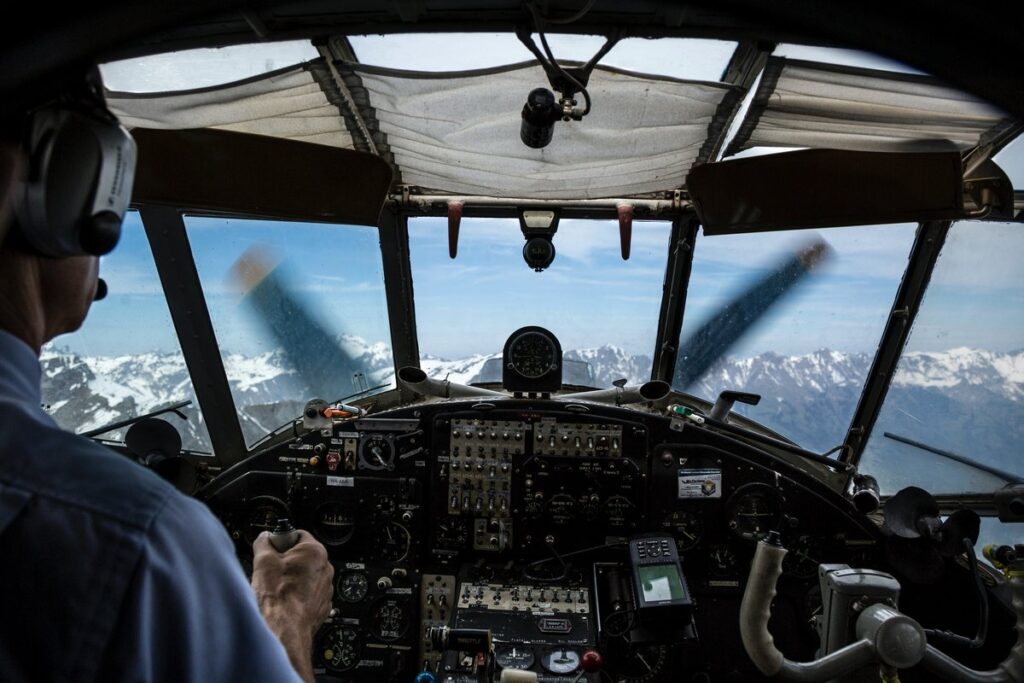 Pilot looking out the front windows of an airplane