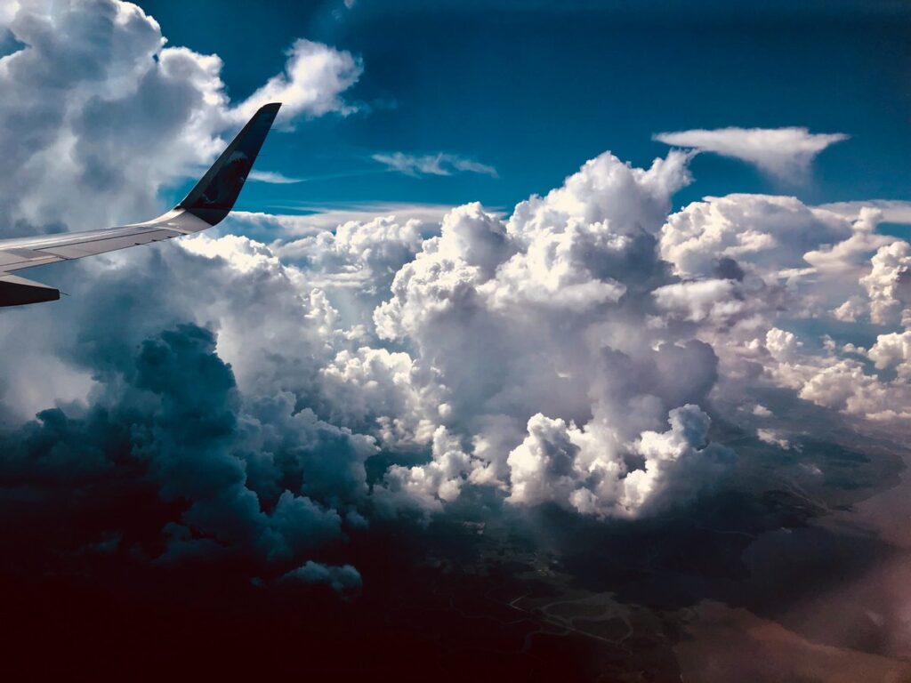 Wing of an airplane flying in very cloudy conditions 